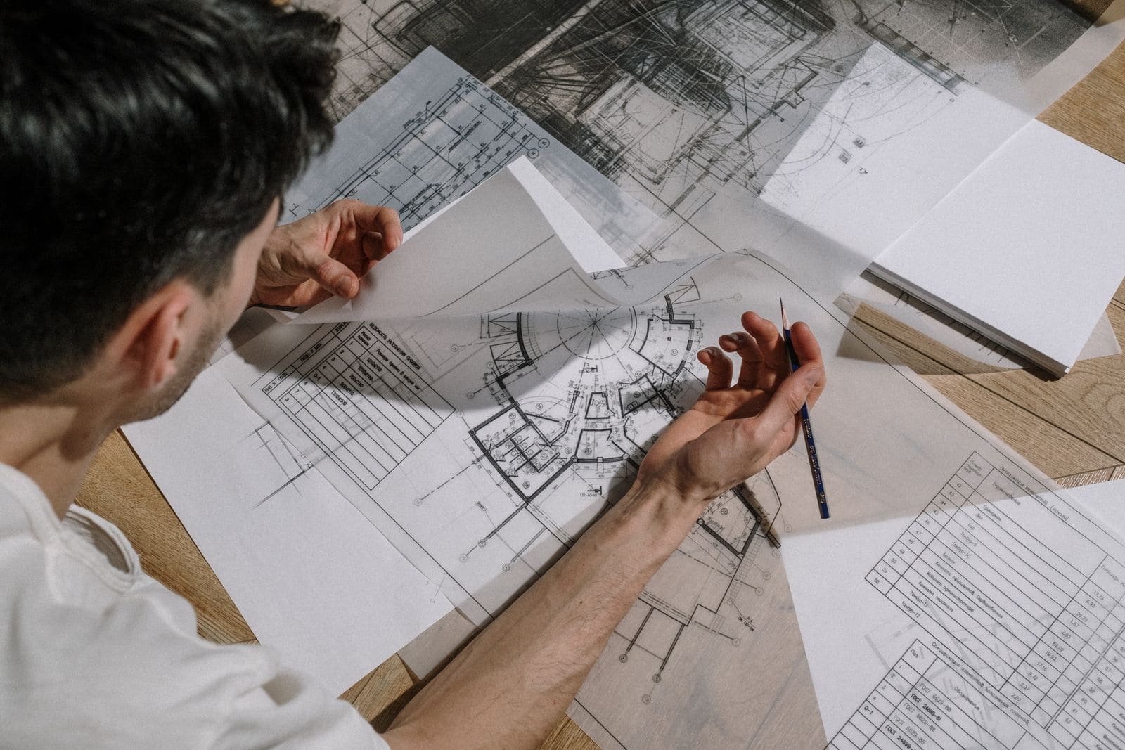 Architect sketching over building plans