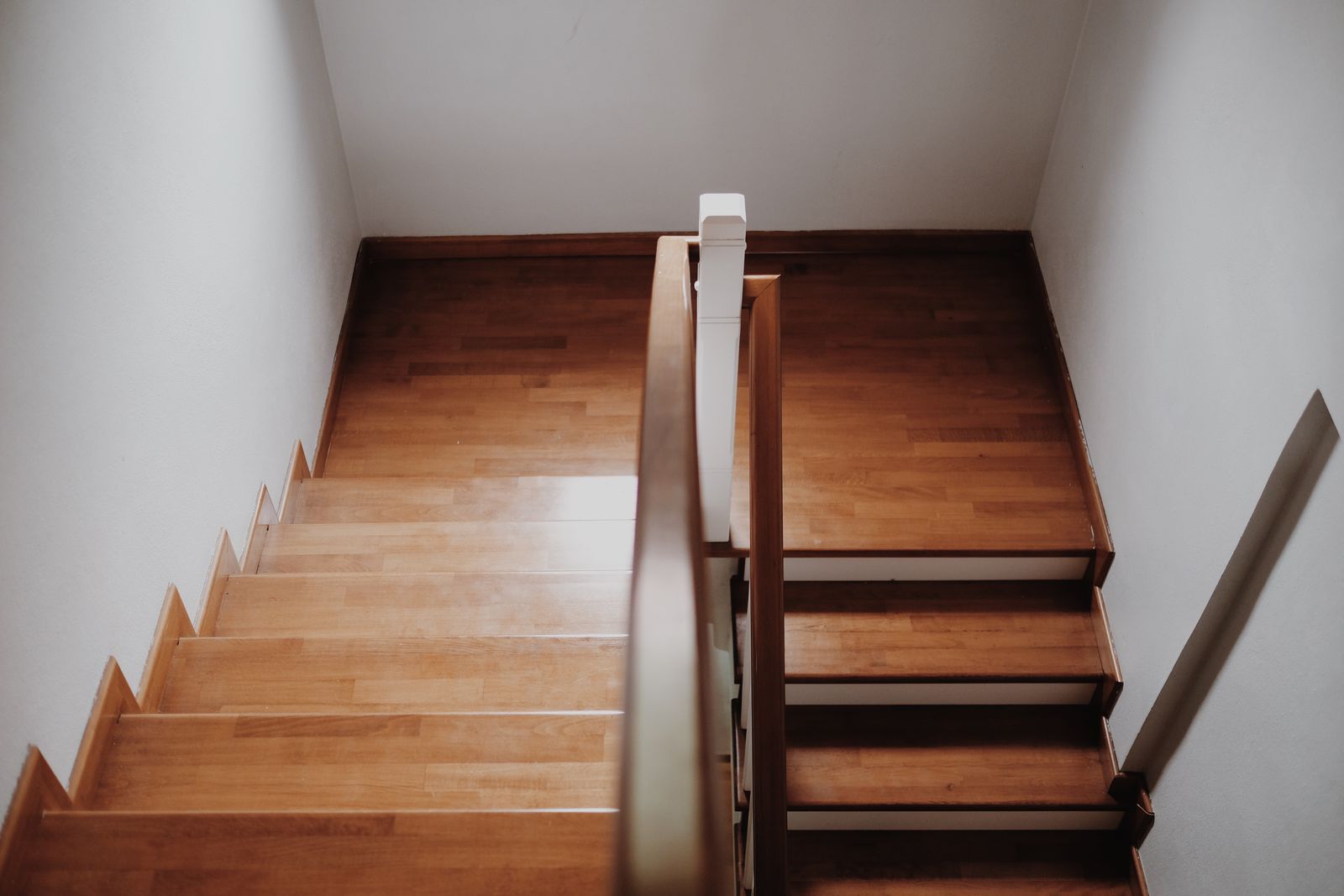 Wooden staircase from above in a minimalist interior